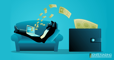 man working on laptop computer with icons representing real estate investment loans