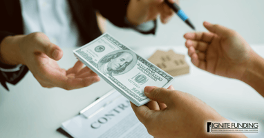 Photo of Trustee and trustor completing a deed of trust; signing contract and exchanging funds from the loan