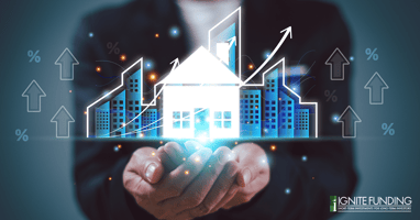 man working on laptop computer with icons representing real estate investment loans